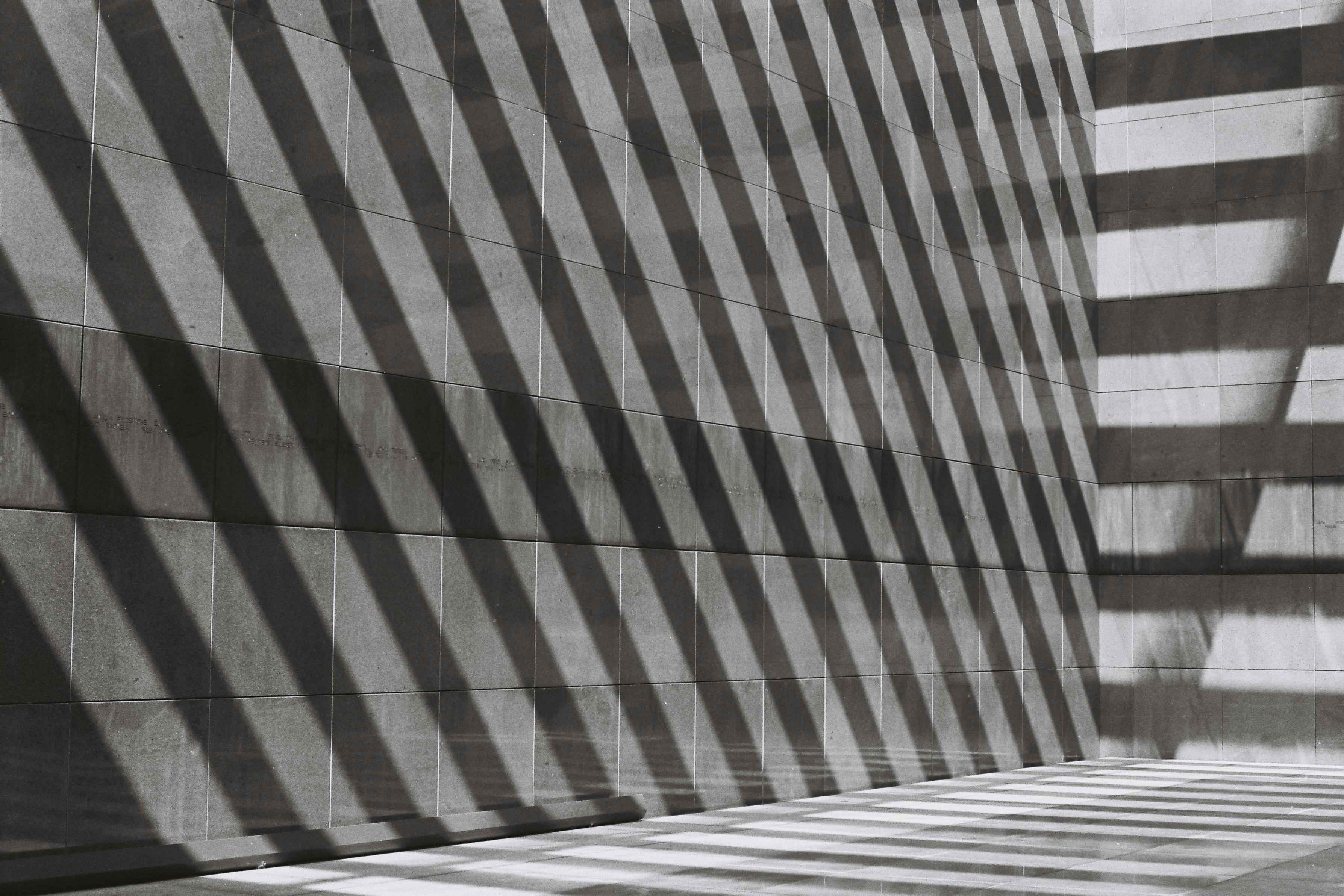 Concrete wall with severe angled shadows.